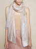 JANE CARR THE ARGENT WRAP - Pale pink pure cashmere scarf with silver metallic border - model