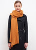 JANE CARR The Luxe in Tan, orange oversized cashmere knit wrap - model 1