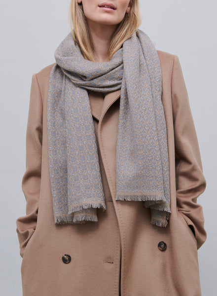JANE CARR, THE TILE SCARF - Camel and grey checked cashmere scarf with silver Lurex - model