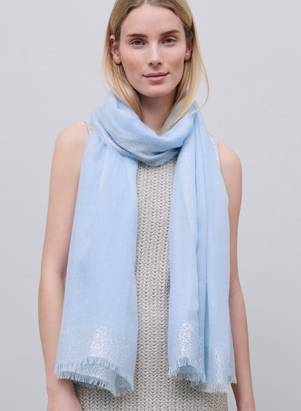 JANE CARR - THE ARGENT WRAP - Pale blue pure cashmere scarf with silver metallic border - model