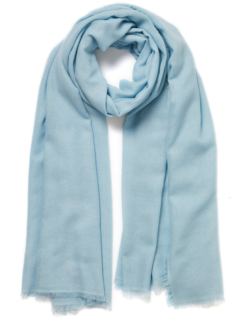 JANE CARR The Fray Wrap in Sky, pale blue woven pure cashmere scarf – tied