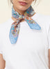 JANE CARR The Prairie Neckerchief in Kingfisher, blue multicolour printed cotton and silk-blend scarf – model