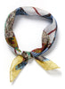 JANE CARR The Prairie Neckerchief in Sultan, yellow and blue multicolour printed cotton and silk-blend scarf – tied