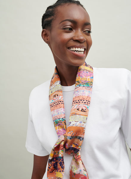 The Anagram Necker, orange and blush multicolour printed silk twill scarf – model 1