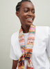 The Anagram Necker, orange and blush multicolour printed silk twill scarf – model 1
