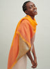 The Shimmer Square, orange pure cashmere scarf with blue metallic border – model 2