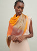 The Shimmer Square, orange pure cashmere scarf with blue metallic border – model